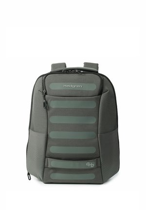 Dark gray Hedgren backpack with padded front panel, multiple horizontal straps, side pockets, and top zipper closure.