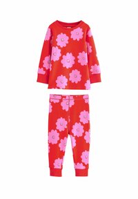 Ensemble de pyjama en coton rouge comprenant un haut à manches longues et un pantalon, orné de grands motifs floraux roses. Texture douce et poignets élastiques.