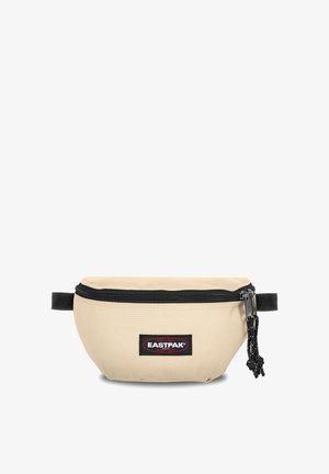 Beige Eastpak fanny pack with a black zipper, logo patch, and adjustable strap. Made from durable fabric, it features a rounded shape and stitched seams.