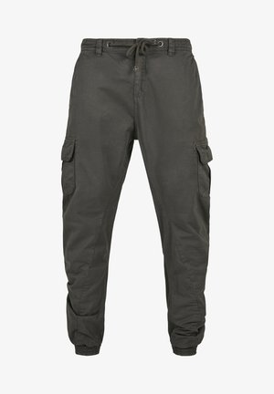 Cargo trousers in dark grey cotton with an elastic waistband, adjustable drawstring, and multiple side pockets. Elastic cuffs at ankles.