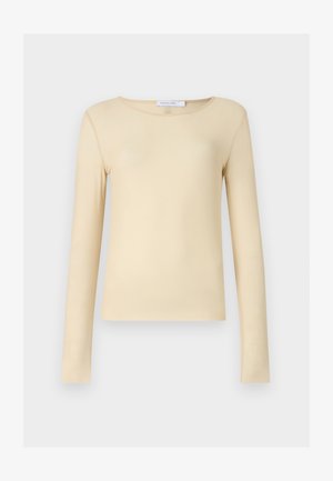 Langermet topp i myk, glatt beige stoff. Har rund hals og et tettsittende design. Minimalistisk uten merkbare mønstre eller detaljer.