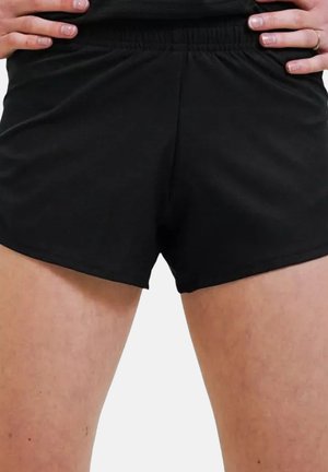 Shorts atletici neri con vita elastica e texture liscia, progettati per comfort e facilità di movimento.