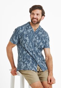 Short-sleeve shirt in navy blue with a leaf pattern in light blue. Fabric is lightweight with a collared design and button front.