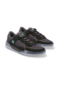 Black and dark purple low-top sneakers with light blue DC logo, laces, and translucent soles shown in a pair on white background.
