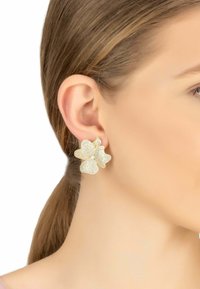 Gold-tone flower earrings featuring a textured surface and sparkling accents, designed to resemble blooming petals.