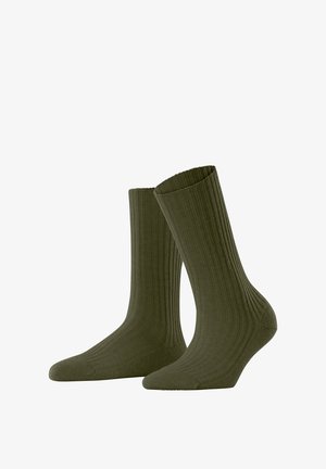 Olivgrüne gerippte Socken mit einer Höhe bis zur Mitte der Wade. Hergestellt aus weichem Stoff, mit einer glatten Textur und einem elastischen Bund für zusätzlichen Komfort.
