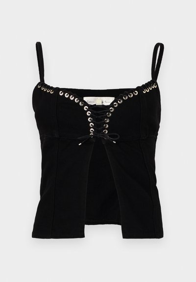 Black fitted top with thin straps, featuring grommet detailing and a lace-up front. The fabric is textured and slightly structured.