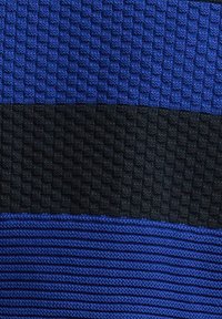 Πλεκτό ύφασμα με τρεις οριζόντιες ρίγες σε μπλε, μαύρο και μπλε, με υφασμένους υφές σε κάθε χρωματική ενότητα.