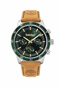 "Timberland" laikrodis su žaliu ciferblatu, auksiniais akcentais, chronografo funkcijomis ir šviesiai rudą odinį dirželį su išsiskiriančiu logotipu.