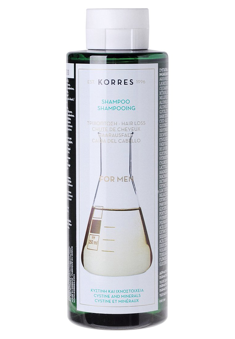 Bottiglia cilindrica verde di shampoo Korres contro la perdita dei capelli, 250 ml, con un'etichetta bianca e turchese che presenta un grafico di un beaker e testo multilingue.