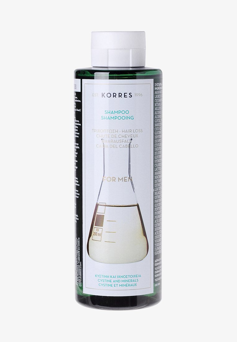 Bottiglia cilindrica verde di shampoo Korres contro la perdita dei capelli, 250 ml, con un'etichetta bianca e turchese che presenta un grafico di un beaker e testo multilingue.