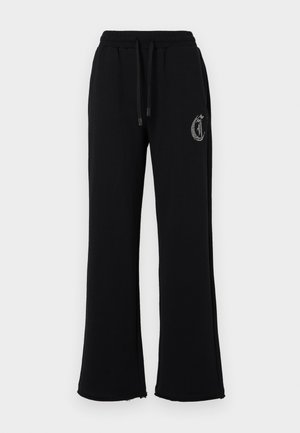 Pantaloni della tuta neri con una vestibilità rilassata, vita elastica, coulisse e decorazione laterale con logo. Realizzati in un tessuto morbido e confortevole.