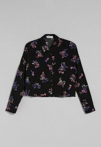 Black cropped button-up shirt with colorful abstract floral patterns in pink and purple. Features a collar and long sleeves.
