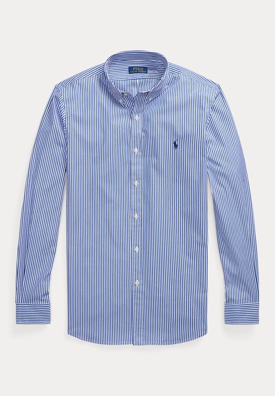 Särgi sinise ja valge vertikaaltriibuga pikkade varrukatega nööbitav särk nööbitava kraega ja Polo Ralph Laureni logo rinnal.