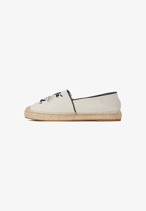 Espadrilles in tela con base crema, rifiniture nere e design floreale ricamato. Presentano una suola in corda di giuta e punta tondeggiante.