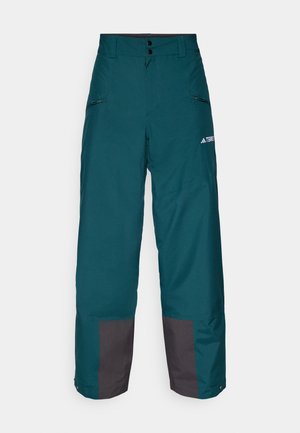 Vattentåliga snöbyxor i teal med grå detaljer. Har hög midja, knappstängning, sidofickor och avsmalnande midja.