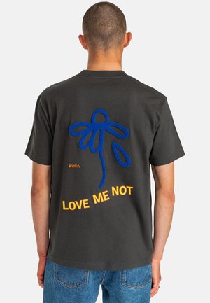 Black cotton t-shirt featuring a blue embroidered flower design and orange text reading "LOVE ME NOT" on the back. Short sleeves, casual fit.