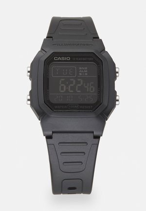 Digital watch with a rectangular black plastic case, LCD display showing time, date, and alarm, and a textured black rubber strap. Water-resistant to 100m.