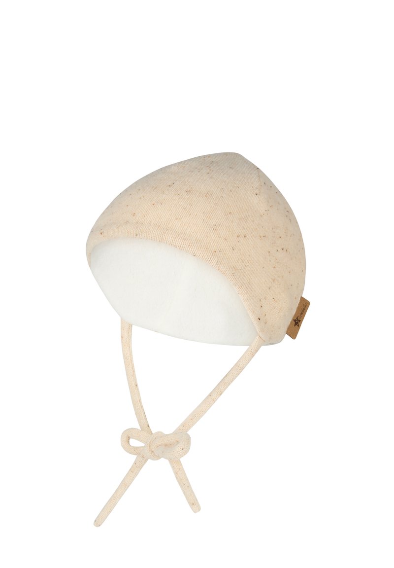 Beige knit baby bonnet with small speckles, soft white lining, and tied straps under the chin.
