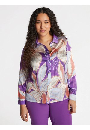 Purple floral blouse with long sleeves and a button-down front. Features vivid multicolored patterns and a smooth satin texture.