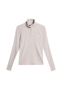 Jasnoróżowa bluzka z długim rękawem, z kołnierzem stójkowym, prążkowaną strukturą, czterema guzikami przy szyi oraz białym logo na lewej piersi.