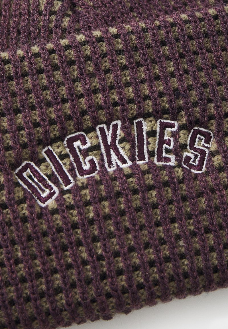 Gorro de punto en color púrpura y verde oliva con un patrón texturizado; presenta el logotipo bordado en blanco "DICKIES". Material suave y cálido.
