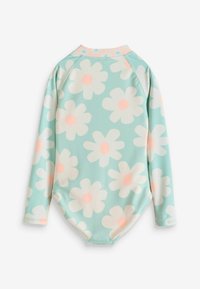 Bodysuit à manches longues en bleu clair avec de grandes marguerites blanches et roses. Tissu lisse, décolleté arrondi et ourlet inférieur courbé.
