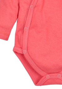 Korallipinkki lyhythihainen body, jossa on pyöreä pääntie ja nepparit edessä ja pohjassa helpottamassa pukemista. Pehmeää puuvillakangasta.