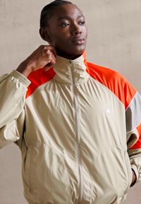 adidas by Stella McCartney TRACKTOP - Training jacket - desert sand/active red