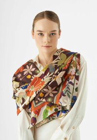 Zijde sjaal met een bloemmotief in levendige kleuren op een bruine achtergrond, met een zachte textuur en een gelaagd ontwerp.