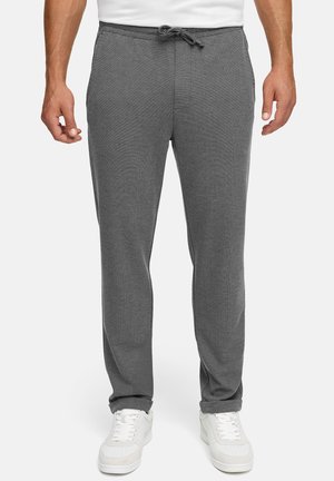 Grå joggebukser laget av mykt stoff, med elastisk midje med snor, sidelommer og smalna ben.