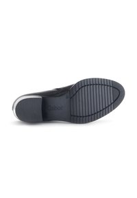 Semelle de chaussure en cuir noir avec caoutchouc texturé, présentant un motif nervuré pour l'adhérence. Logo "Gabor" en relief près du talon. Fini lisse.
