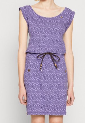 Purple sleeveless dress with geometric pattern, brown drawstring belt with wooden beads, worn by standing person with arms relaxed.