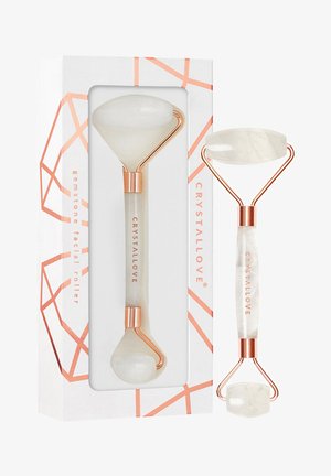 Roller do twarzy z kamieni szlachetnych z końcówkami z białego jadeitu i ramą z różowego złota. Zapakowany w pudełko w geometryczny wzór z brandingiem.