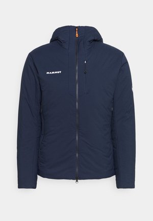 Laivastonsininen hupullinen takki, jossa on edessä vetoketju, rintataskun vetoketju ja valkoinen "Mammut"-logo vasemmassa rinnassa.