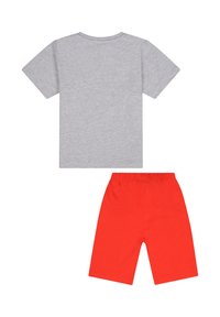 Graues Baumwoll-T-Shirt mit kurzen Ärmeln, kombiniert mit roten elastischen Shorts. Beide Teile haben ein simples, lässiges Design.