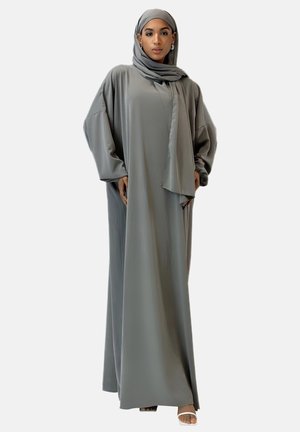 Długa, swobodna abaya w miękkim szarym materiale o luźnym kroju. Zawiera dopasowany hijab i szerokie rękawy, oferując minimalistyczną estetykę.
