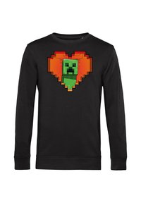 Svart långärmad sweatshirt med en pixeliserad grön karaktär inuti ett röd-orange hjärtformat mönster, tillverkad av mjukt tyg.