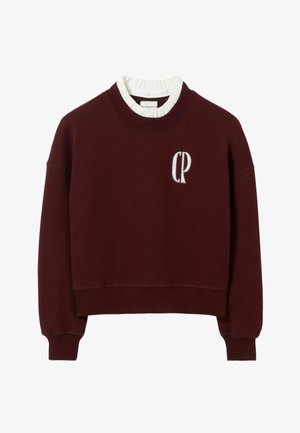 Felpa bordeaux con un design corto, colletto e polsini a costine. Presenta un logo ricamato "CP" sulla parte anteriore. Materiale in cotone.