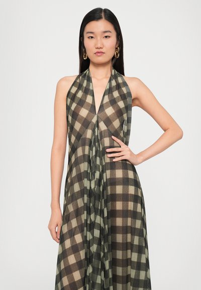 Halterneck dress made of lightweight fabric, featuring a brown and beige plaid pattern, draped design, and a deep V-neckline.