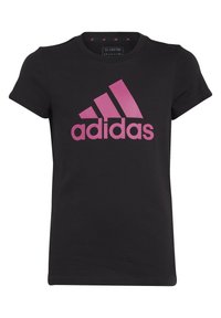 Maglietta nera in cotone a maniche corte, con un grande logo rosa Adidas sul davanti. Design con scollo tondo. Taglio semplice e classico.