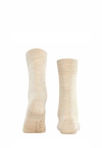 Chaussettes en mélange de coton beige, de longueur mi-mollet, avec une texture lisse et des bords côtes. Marquage subtil imprimé sur la semelle.