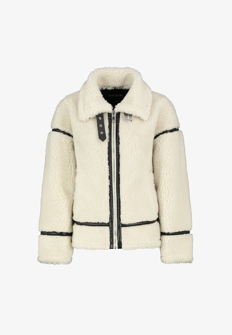 Cream-colored faux shearling jacket with black trim, a collared neckline, and a front zipper. Features oversized sleeves and a boxy shape.