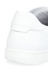 Białe skórzane sneakersy o gładkiej fakturze, niskim kroju i gumowej podeszwie z subtelnymi detalami przeszycia na pięcie.