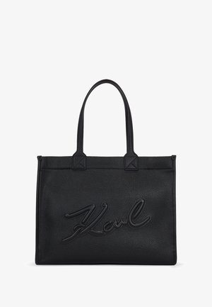 Borsa tote in pelle nera con una finitura testurizzata, con logo "Karl" in rilievo, manici doppi e angoli della base quadrati.