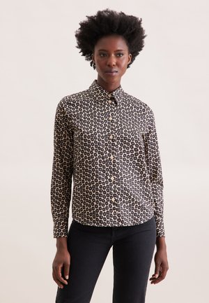 Camicia abbottonata con motivo floreale nero e beige, maniche lunghe e colletto. Realizzata in tessuto leggero. Caratterizzata da chiusura a bottoni.