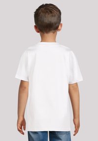 Witte t-shirt met korte mouwen, gemaakt van katoen, met een ronde hals en een losse pasvorm, gezien van achteren tegen een grijze achtergrond.