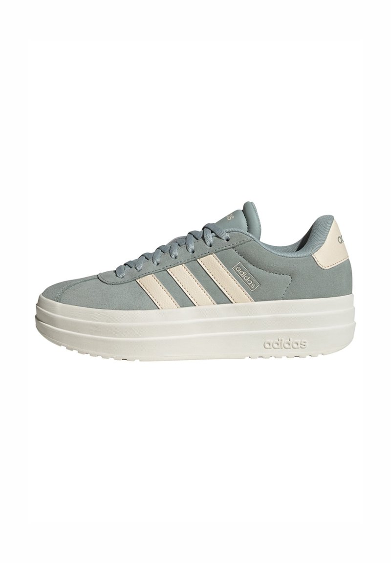 Light blue suede sneakers with cream accents, three side stripes, padded tongue, and a thick white sole featuring embossed branding.