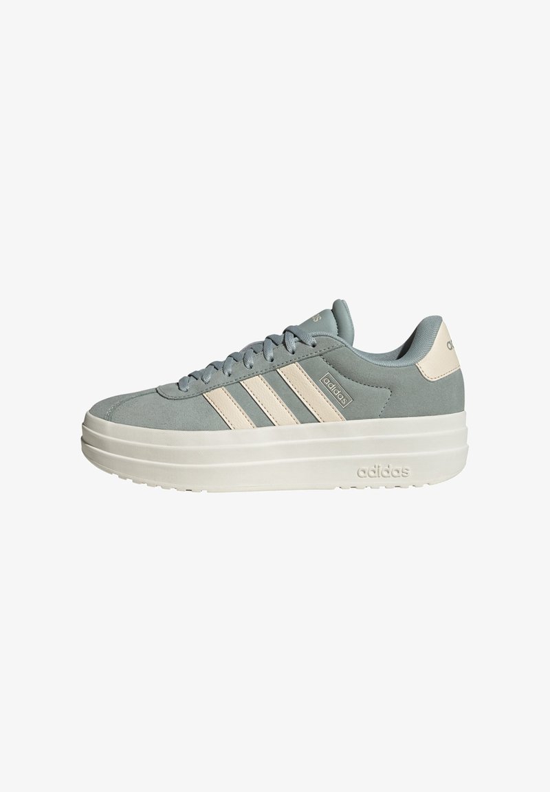 Light blue suede sneakers with cream accents, three side stripes, padded tongue, and a thick white sole featuring embossed branding.