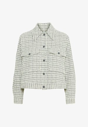 Veste en tweed blanche et marine avec un col, deux poches avant et des fermetures à bouton. Longueur cropped et tissu texturé.